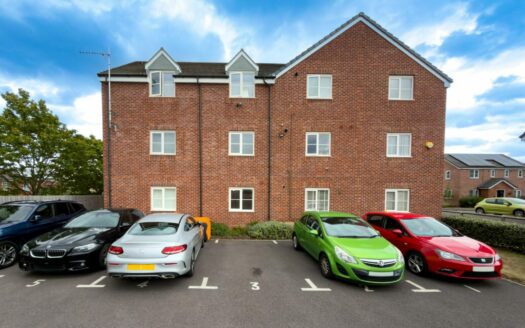 Exterior of the apartment block on Exel Drive, Tyseley, with allocated parking bays